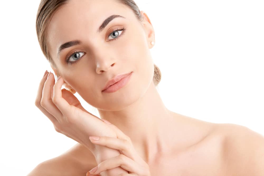 Beautiful,Young,Woman,With,Glowing,Skin,Looking,At,Camera,And